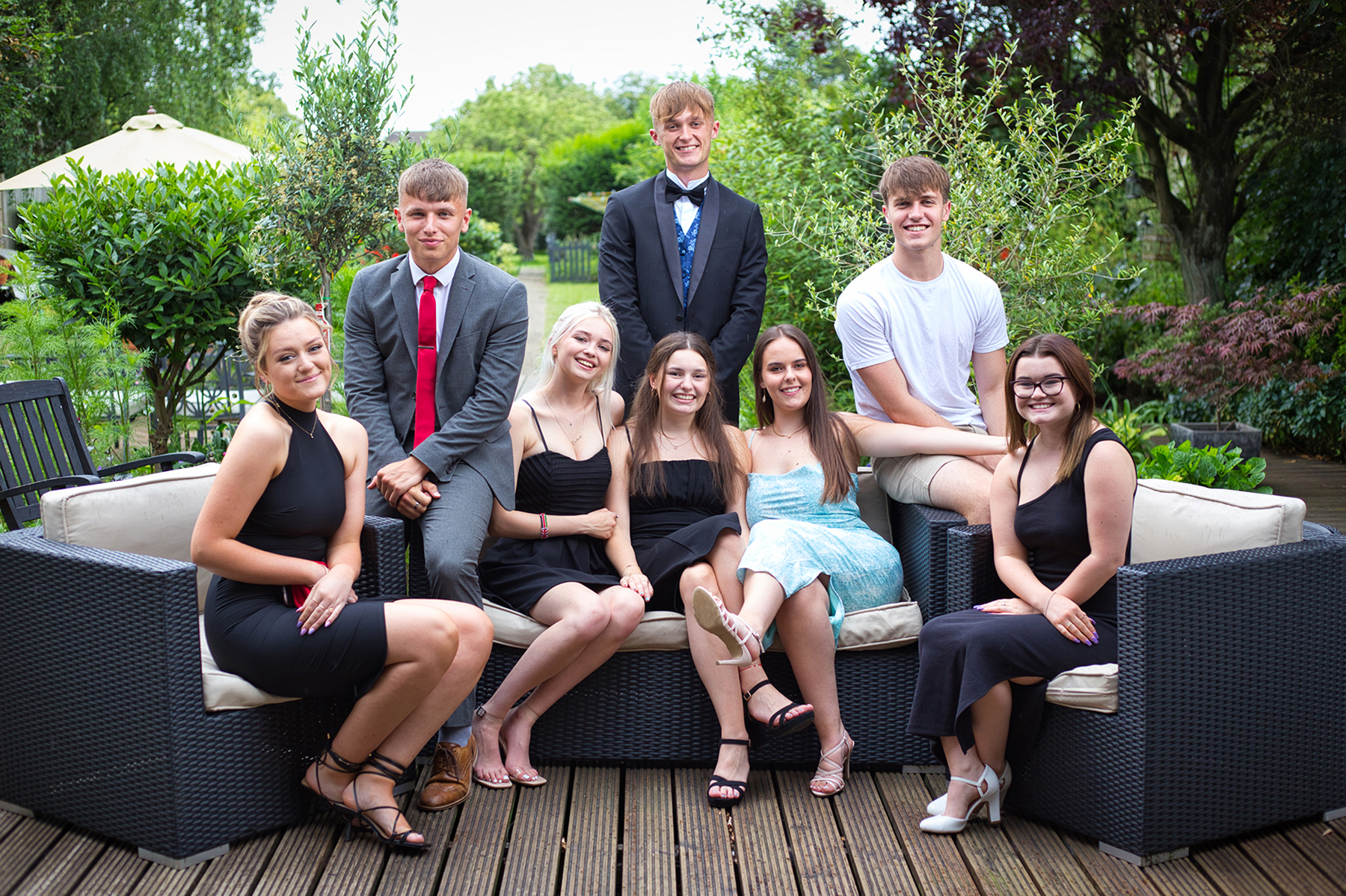 Group portrait of friends in garden on Prom Day